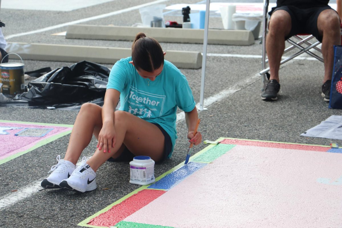 The seniors hard at work painting their parking spots on August 2nd, 2025.