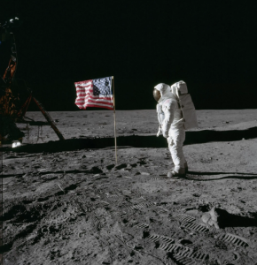Apollo astronaut Buzz Aldrin poses for a photograph beside the deployed United States flag during an Apollo 11 moonwalk on July 20, 1969. The Lunar Module is on the left, and the footprints of the astronauts are clearly visible in the soil of the moon. 